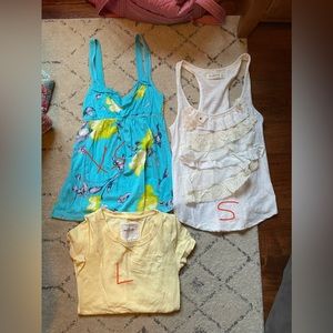 Blue one is Hollister, yellow t shirt and white tank are  Abercrombie and Fitch